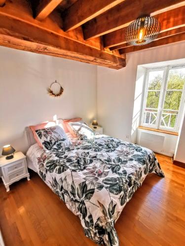 une chambre avec un lit dans une pièce avec des plafonds en bois dans l'établissement Moulin des ducs grand format by Vindihouses - piscine chaffée - escalade - billard - fitness - etc, à Épinac-les-Mines