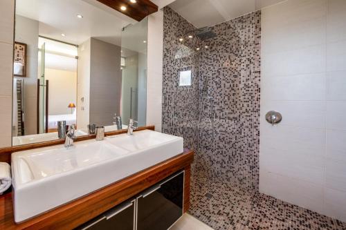 a bathroom with a white sink and a shower at Mar da Luz Resort in Luz