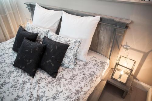 a bed with pillows on it with at Hotel Wodnik in Wrocław