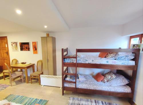 a room with three bunk beds and a dining room at Summit Apartment in Žabljak