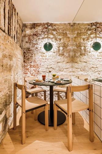 a dining room with a table and two chairs at Hôtel Mathis Elysées in Paris
