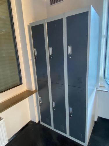 a row of lockers in a room with a window at Capsule Hostel by StayStay in Nuremberg