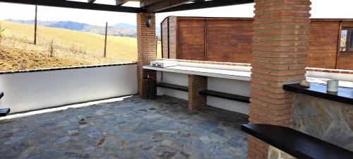 an outdoor patio with a view of a field at B&B Casa Loré D'or in Alora