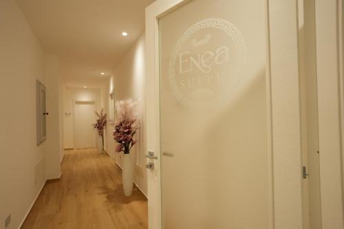 a hallway with a white door with a sign on it at Enea Suite in Trapani