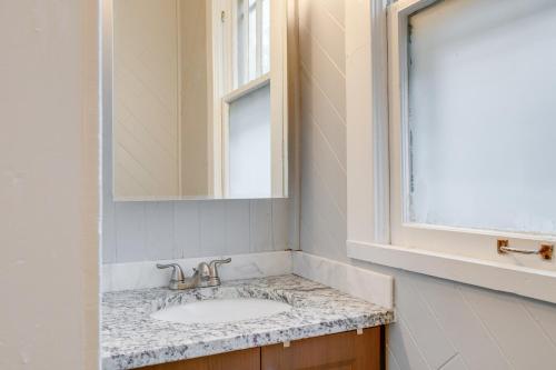 baño con lavabo, espejo y ventana en Denver Vacation Rental Blocks to Washington Park, en Denver