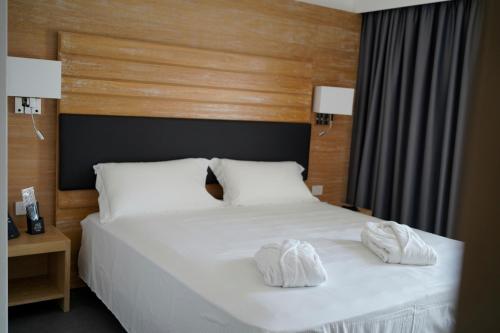 a bedroom with a bed with white towels on it at PM Hotel in Catanzaro Lido