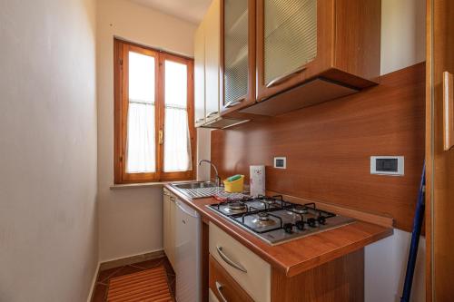 a small kitchen with a stove and a sink at Villa Magnolia in Bolsena
