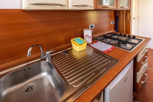 a kitchen with a sink and a stove at Villa Magnolia in Bolsena