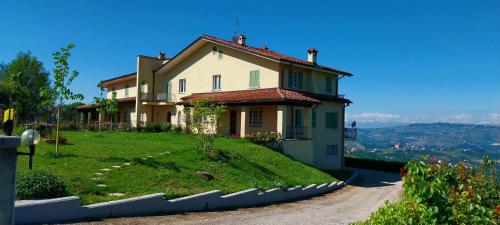 a house on top of a grassy hill at Villa Bellavista Alba, B&B in Alba