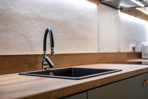 a kitchen counter with a sink in a kitchen at Valentin36 Apartment Raschötz in Funes