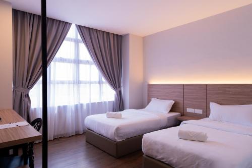 Una cama o camas en una habitación de RM Hotel Muar