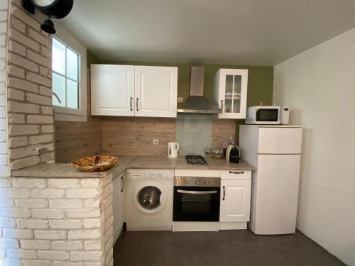 a kitchen with a white refrigerator and a dishwasher at L’ardoisière in Honfleur