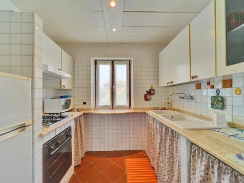 a kitchen with white cabinets and a sink at Villa Magnolia in Bolsena