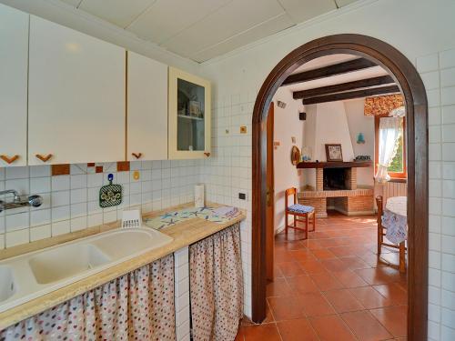 a kitchen with a large sink and an archway at Villa Magnolia in Bolsena