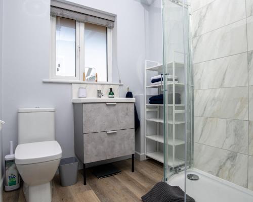 a bathroom with a shower and a toilet and a sink at B’s house in Simpson