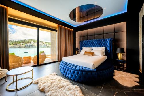 a bedroom with a large bed with a large window at Ushuaia Playa Xemxija Boutique Hotel in St. Paul's Bay