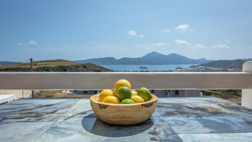 a bowl of fruit sitting on top of a table at Thea Sunset Suites in Mytakas