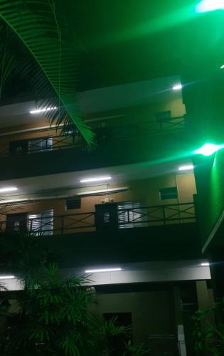 a building with green lights on top of it at SALATA Hotel CENTRO in Jardinópolis