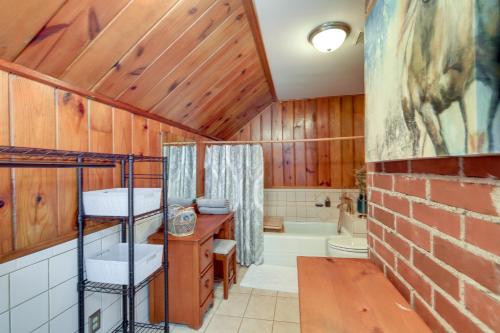 a bathroom with wooden walls and a brick wall at Quiet Ellaville Home with Patio and Outdoor Dining! 