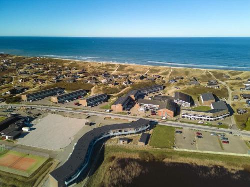 an aerial view of a parking lot next to the ocean at Loft apartment in holiday park, Ringkøbing in Ringkøbing
