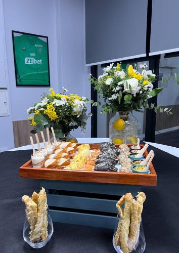 a table with a buffet of food and flowers at Best Western Hotel le Galice Aix-en-Provence in Aix-en-Provence