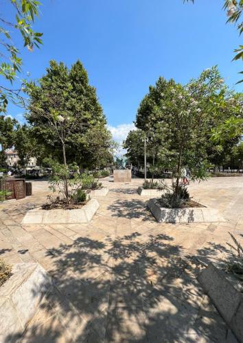 a park with two trees in the middle at Best Western Hotel le Galice Aix-en-Provence in Aix-en-Provence