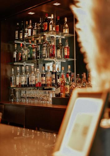 a bar with a lot of bottles of alcohol at Best Western Hotel le Galice Aix-en-Provence in Aix-en-Provence