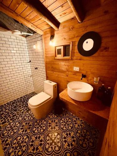 a bathroom with a toilet and a sink at ThanSam Cabaña in San Vicente