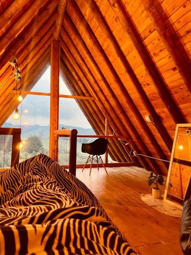 a zebra print bed in a room with a window at ThanSam Cabaña in San Vicente