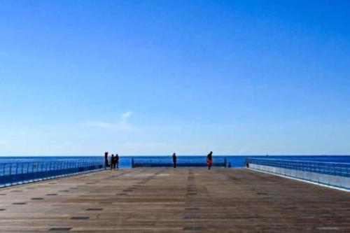 a group of people standing on a pier at Appartement 2 pièces de 29 m2 in Cannes