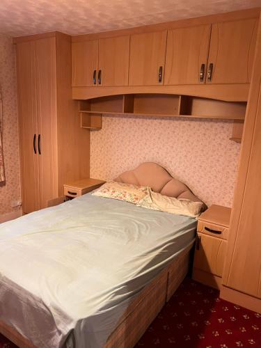 a bedroom with a bed with a woman laying on it at Whitby road house in Canvey