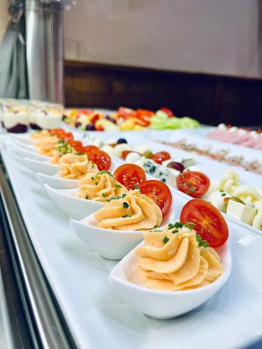 a buffet line of plates of food on a table at Penzion Katarina in Ždiar