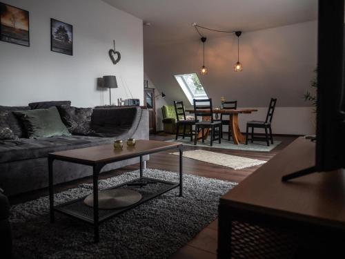 a living room with a couch and a table at Mühlberg, Ferienwohnung in Schneverdingen