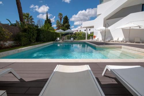 a swimming pool in the backyard of a house at Evora Olive Hotel in Évora