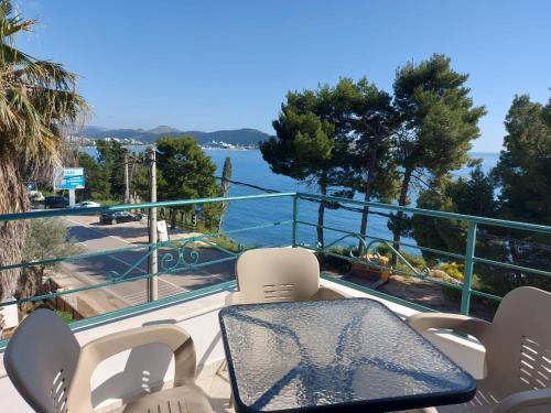 a table and chairs on a balcony overlooking the water at Apartmani Sunce in Bar