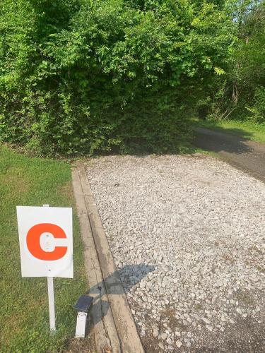 a sign sitting on the side of a gravel road at Log Cabin in the Field in Huntington
