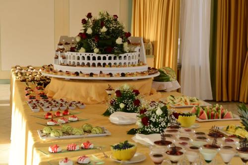 a table with a cake and a bunch of food at Hotel Villa Degli Angeli in Castel Gandolfo