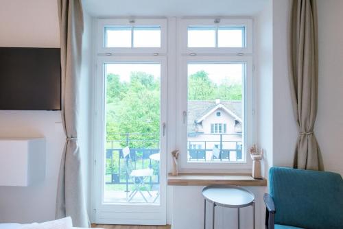 a room with a window with a view of a house at HITrental Riesbach Apartments in Zurich