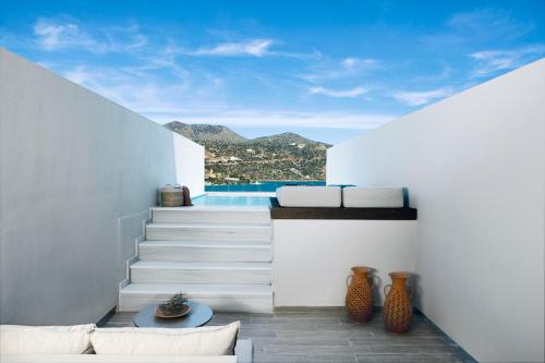 a view of a house with stairs and a pool at Wyndham Grand Crete Mirabello Bay in Agios Nikolaos