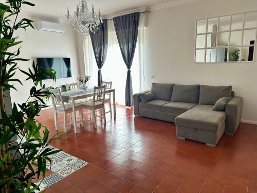 a living room with a couch and a table at Anema & Core Home in Porto SantʼElpidio