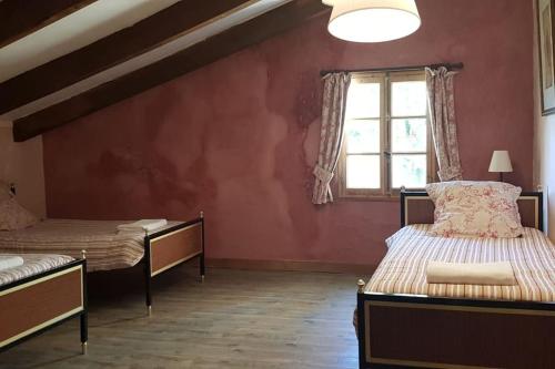 a bedroom with two beds and a window at Domaine de la Bastide Basse in Signes