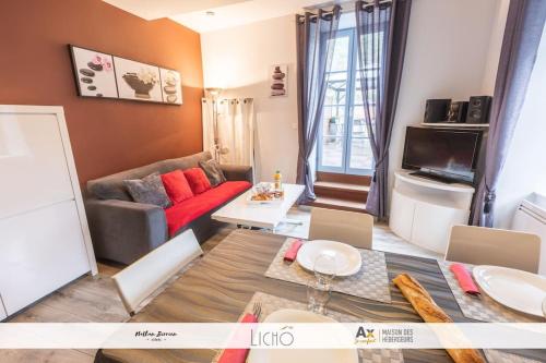 a living room with a couch and a table at T3 Calimero Ax le Régina classé clé vacances 6 couchages in Ax-les-Thermes