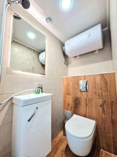 a small bathroom with a toilet and a sink at The Little Prince studio in Varna City