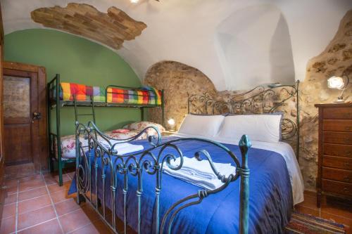 a bedroom with a bed with a blue comforter at CASA Flag Tur in Castel del Monte