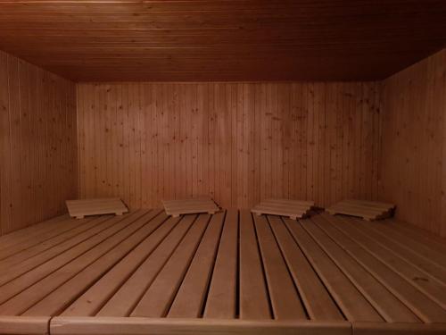 a sauna with three benches in a wooden room at Prada Laax by Quokka 360 - building with sauna in Laax