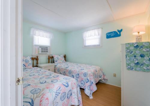a bedroom with two beds and a window at 131 #3 North Shore Boulevard East Sandwich - Waters Edge #3 in Sandwich