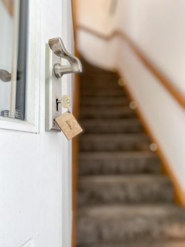 a door with a tag on it with a staircase at Hawkshead Suites in Hawkshead