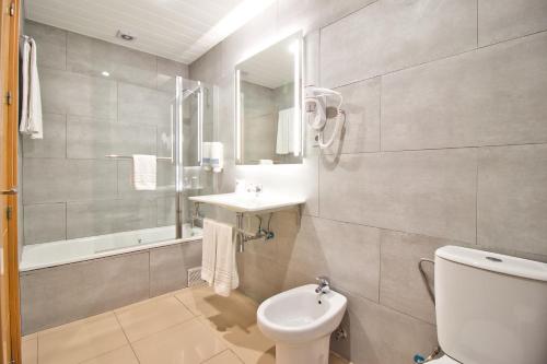 a bathroom with a toilet and a sink at Atenas Granada in Granada