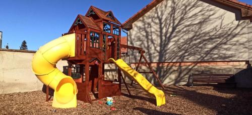 a playground with a slide in front of a building at Chata Lucie pod Řípem in Roudnice nad Labem