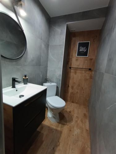a bathroom with a toilet and a sink and a mirror at Studio nad Kanałem in Kłodzko
